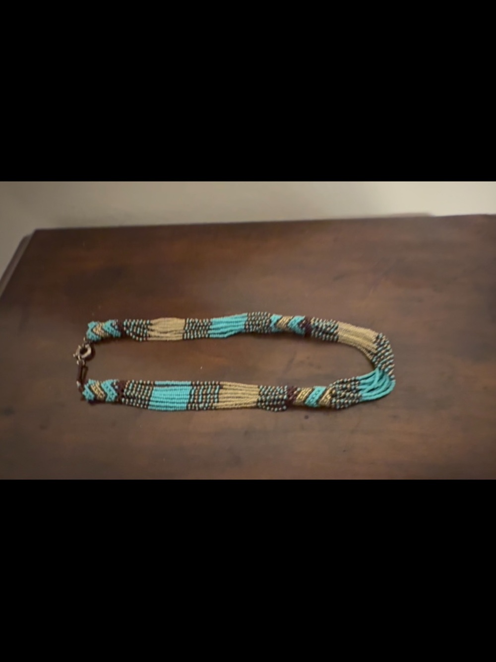 Multi colored, woven strand bead necklace, used but lightly.